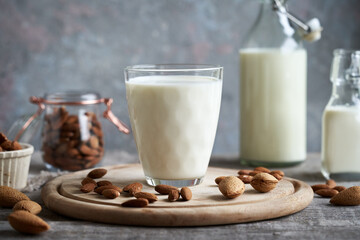 A cup of vegan almond milk with almonds