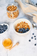 Homemade granola with nuts and fresh blueberries for breakfast. Healthy breakfast. Vegetarian food concept