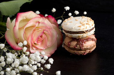Fototapeta na wymiar Macro Image of Chocolate Macarons with Pink Rose