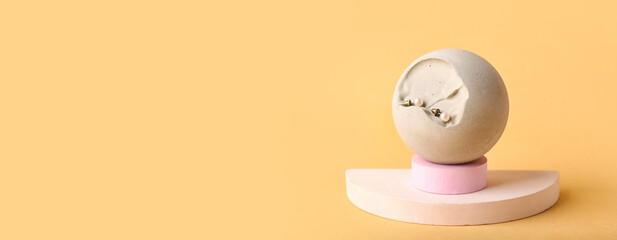Modern podium with stylish pearl earrings on orange background with space for text