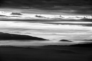 Mist and fog between valley and layers of mountains and hills