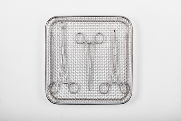 Surgical instruments in a tray on a white - 566393699