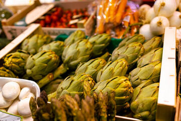 Beautiful and healthy green fresh artichoke vegetables lie in plastic boxes at the Spain street market. 
