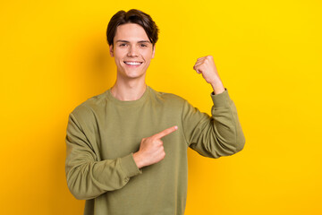 Portrait of positive nice person toothy smile direct finger arm raise fist show biceps isolated on...