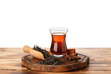 Board with cup of Turkish tea, dry leaves and spices on wooden table against white background