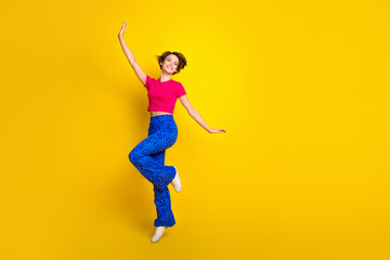 Fototapeta na wymiar Full length photo of overjoyed cheerful lady wear pink bright clothes have fun good mood empty space isolated on yellow color background