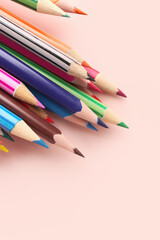 Set of colorful pencils on pink table, closeup