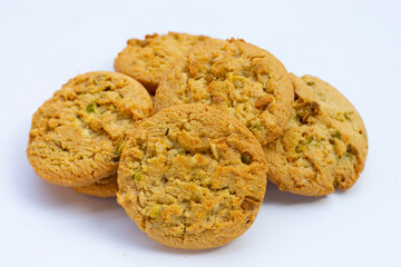 Pistachio and almond cookies on white background.