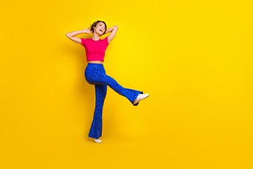Fototapeta na wymiar Full length photo of optimistic positive lady wear trendy clothes celebrate birthday empty space isolated on yellow color background