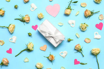 Composition with gift box, rose flowers and decor on color background