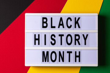 Lightbox with text Black History Month on red, yellow, green, black color background. Top view