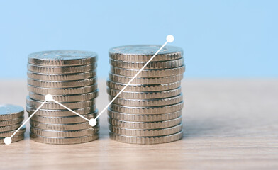 A stack of metallic coins and a chart with growing rates. High income in business, price increase,...