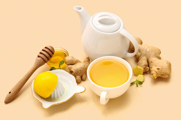 Composition with cup of tea, ginger, honey, mint and lemon on beige background