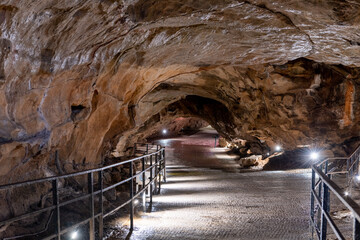 An illuminated passageway inside Goughs Cave in Cheddar