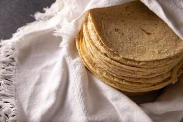 Corn Tortillas. Food made with nixtamalized corn, a staple food in several American countries, an...