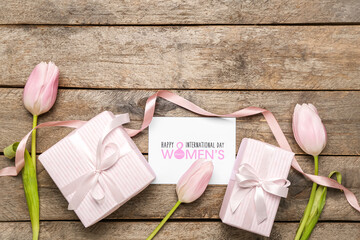 Composition with gift boxes, greeting card and tulip flowers on wooden background. Women's Day celebration