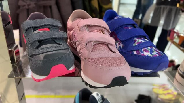 Children's Velcro sneakers stand in a shoe store window
