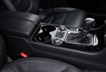 Fototapeta na wymiar Automatic transmission gearshift stick, Closeup a manual shift of modern car gear shifter. Close up of the automatic gearbox lever, black interior car. Detailing interior lux car. Lux car interior
