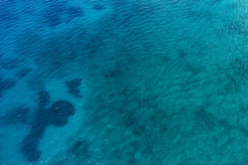 Fototapeta na wymiar Shallow water and reef by 7 km long beach in village Borsh, Albania in Summer 2022