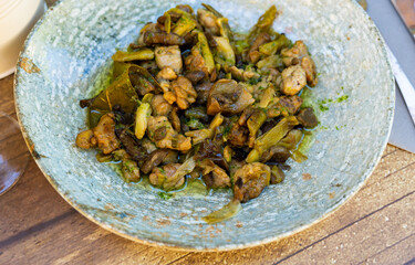 Portion of traditional Aragonese dish, lechecillas de ternasco, served on plate.