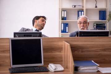 Two male colleagues working in the office