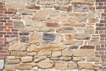 texture of rough masonry yellow rough bricks and cement between them, stone wall