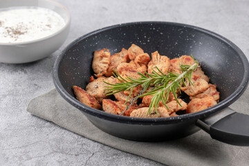 Greek gyros in a frying pan on a gray background