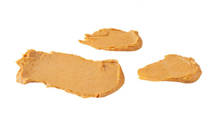 smears and splashes of peanut butter isolated on white background.