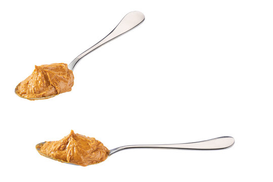 peanut butter in a spoon isolated on white background, clipping path. Creamy peanut butter in spoon.