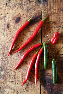 Overhead view of chili peppers on wooden table