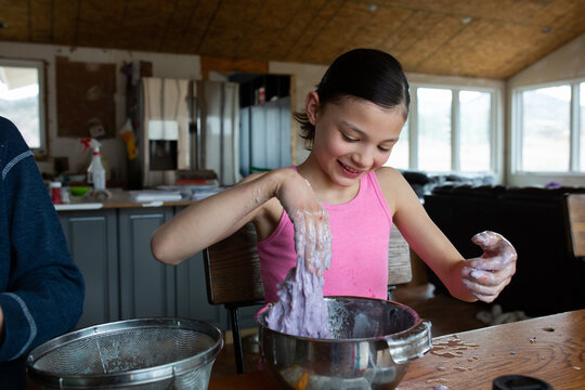 Tween girl playing with slime she just made