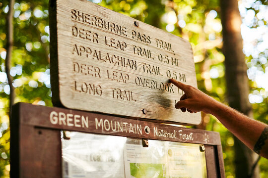 A Male Hiker Reading Wooden Sign Board Along The Appalachian Trail