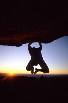 A climber bouldering at sunset, Moab, Utah.