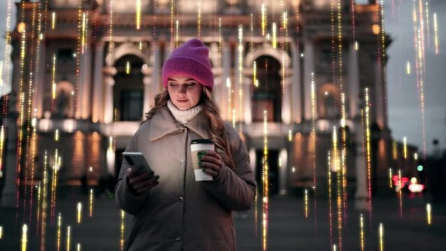 Charming young blond woman walk down the night city street with cup of coffee and using smartphone mobile phone Internet by information lines flying to the global communication digital network concept