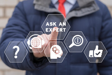 "Ask an expert" business concept. Businessman using virtual touchscreen presses inscription: ASK AN EXPERT. Expert Advice Consulting Help Support Service.