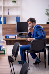 Young male employee working in the office