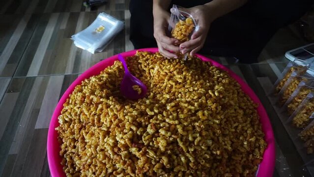Stock footage of macaroni snacks being packed