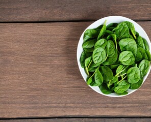 spinach leaves on a wooden background, top view with copy space.