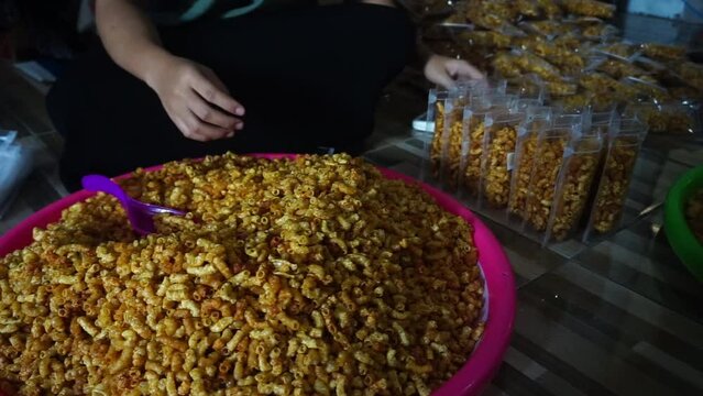 Stock footage of macaroni snacks being packed