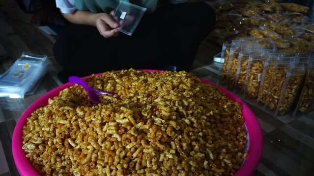 Stock footage of macaroni snacks being packed