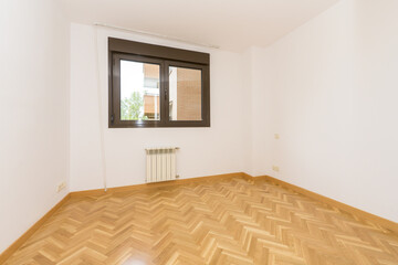 Empty white painted living room with oak woodwork on the floor and skirting boards, double pane...