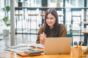 young student wearing headphones studies online, distance learning, and keeps up to date on the global coronavirus pandemic..