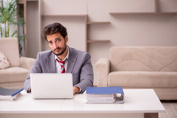 Young male employee working from home during pandemic