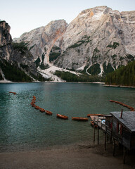 Accommodated boats in Lago di Braies in Dolomites, Italy, starting the Autumn at sunrise, ready to sail