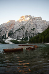 A Beautiful view of Lago di Braies boats, at sunrise, in Dolomites, Italy