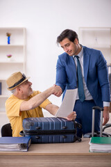 Old male boss and young male employee in summer vacation concept