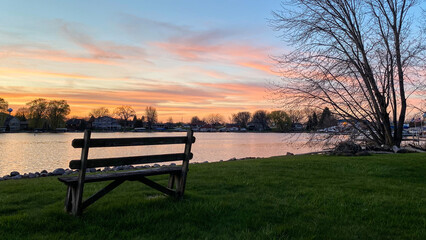 bench by the river channel at sunset