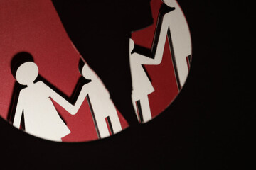 Human figures reflected in broken mirror on black background. Divorce concept
