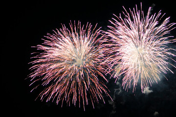 Fireworks light up the sky with dazzling display. Shining Fireworks with golden ring. Celebration fireworks. 