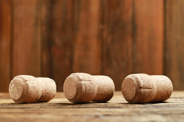 Corks of wine bottles on wooden table, closeup